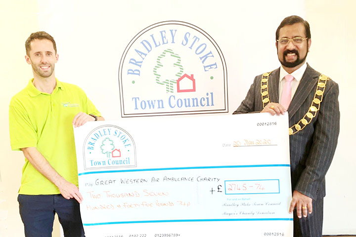 Photo of Cllr Tom Aditya handing over the cheque to Joe Hughes from The Great Western Air Ambulance