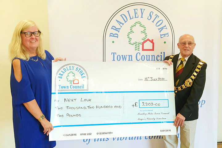 Photo of Cllr Tony Griffiths handing over the cheque to Mrs Jayne Whittestone from Next Link