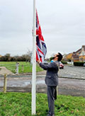 Photos of Mayor of Bradley Stoke Cllr Tom Aditya hoisting a new Union Jack at the flagpole in the Queen's Jubilee Green