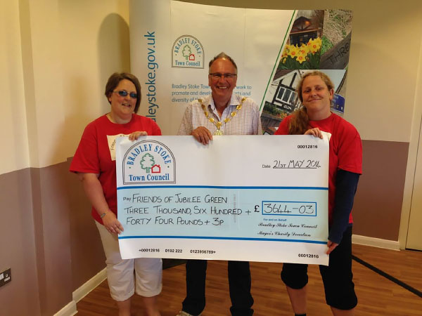 Former Mayor Councillor Brian Hopkinson presents a Charity Cheque to 'Friends of Jubilee Green' (Pictured Michelle Dent & Helen North).