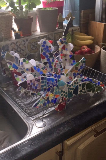 Photo of a Mosaic Birds drying in a wire rack